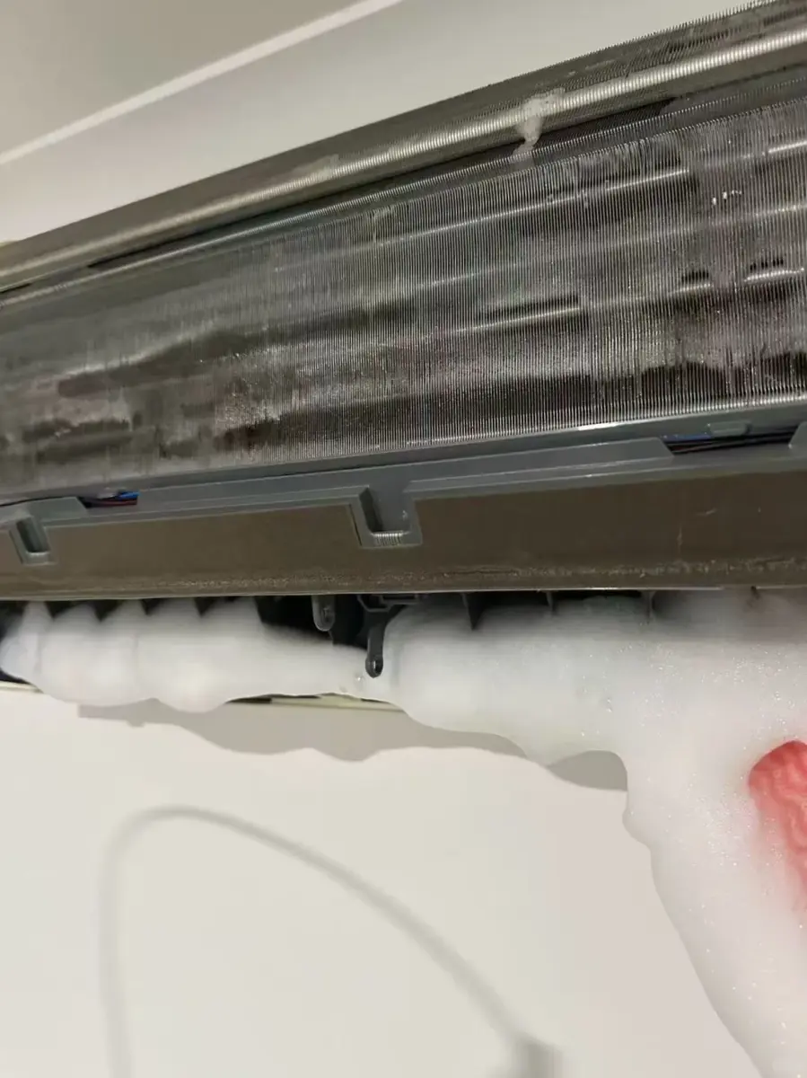 Close view of ice buildup on an indoor air conditioner coil