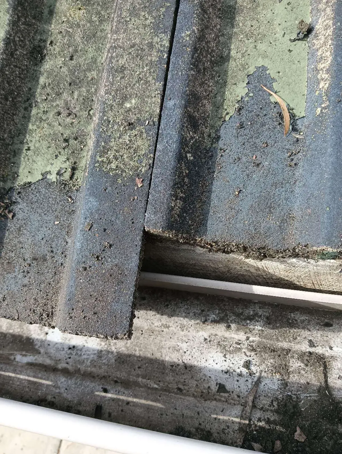 Close view of a tile roof valley debris collection point